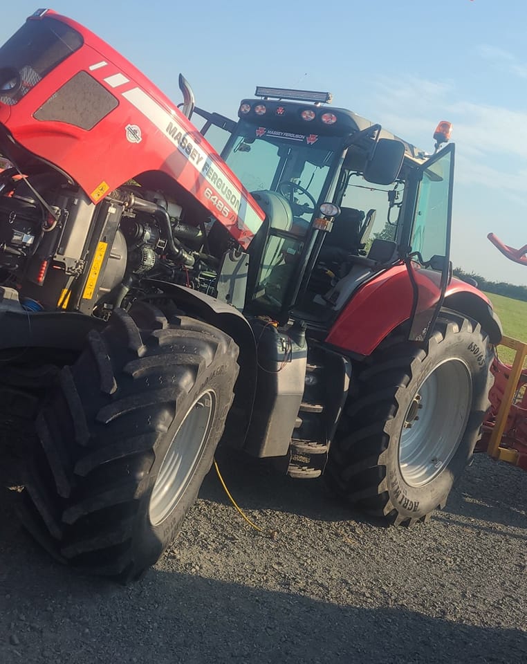 Image of and air conditioning unit being serviced on a Massey Ferguson tractor 